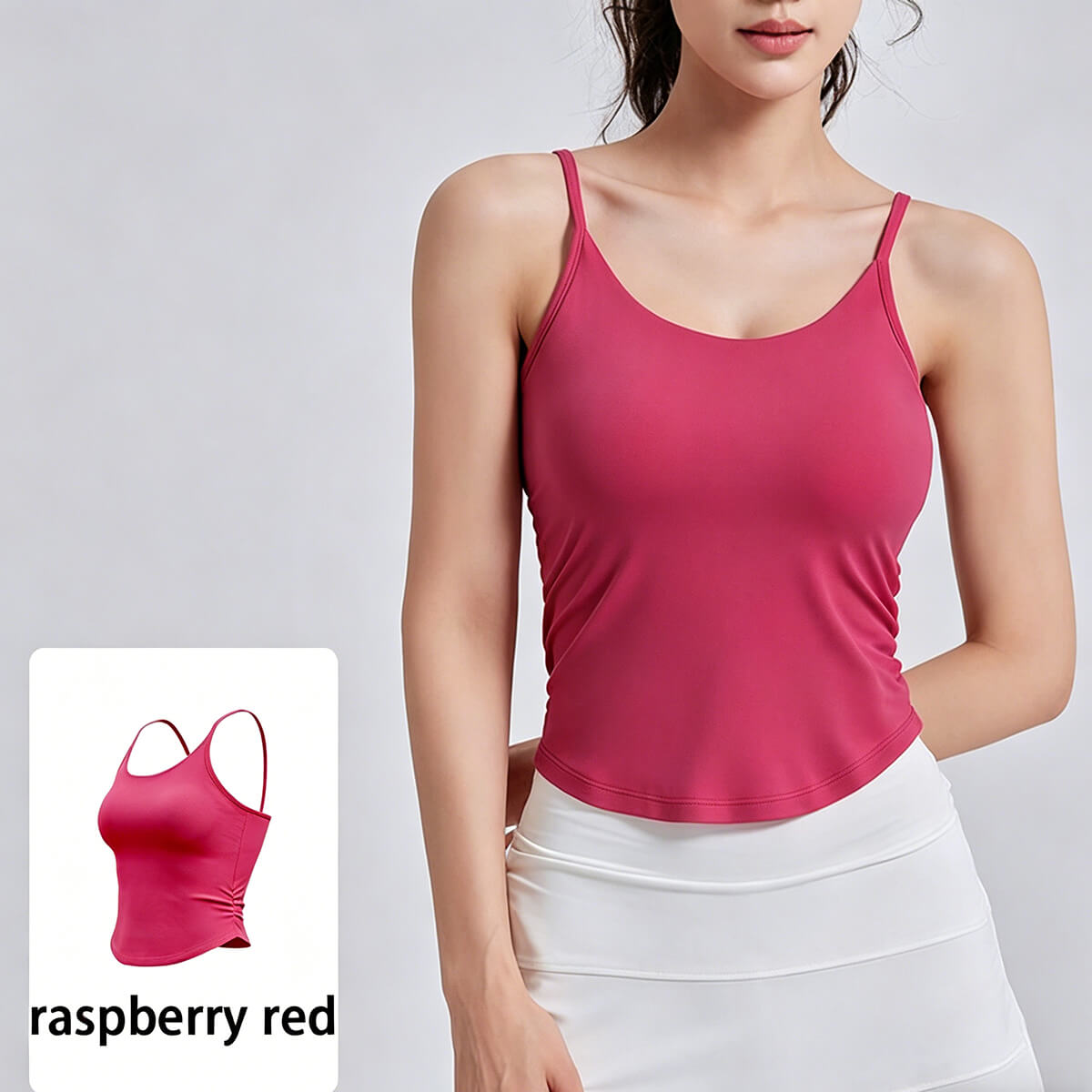 Woman wearing a raspberry red workout tank top with a built-in bra, showcasing the vibrant color and moisture-wicking performance fabric