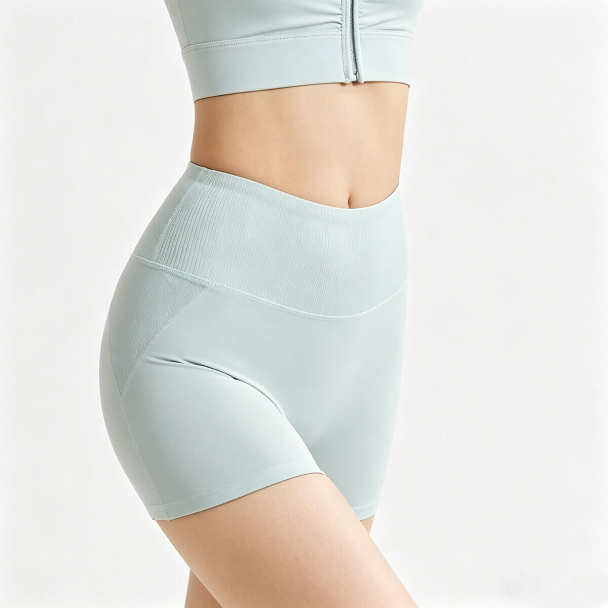 Side profile of light blue athletic workout shorts showing the seamless high-rise ribbed waist and stretchy fitness fabric