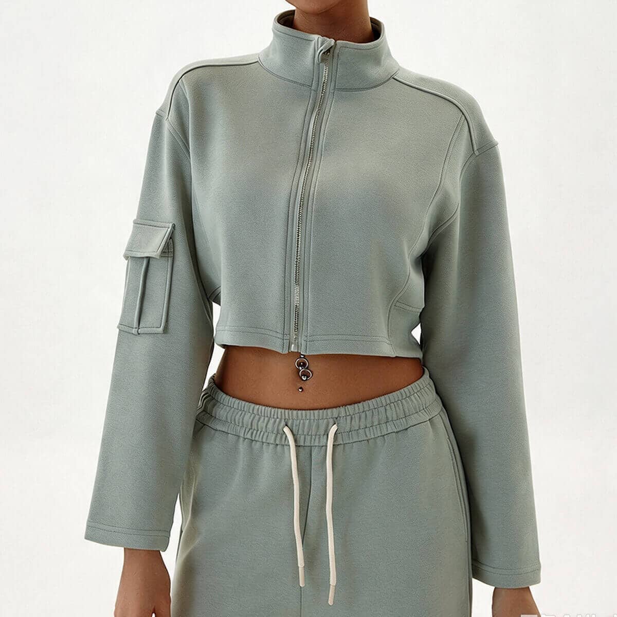 Sage green cargo athleisure set for women featuring a mock neck zip-up crop top and utility cargo pockets.