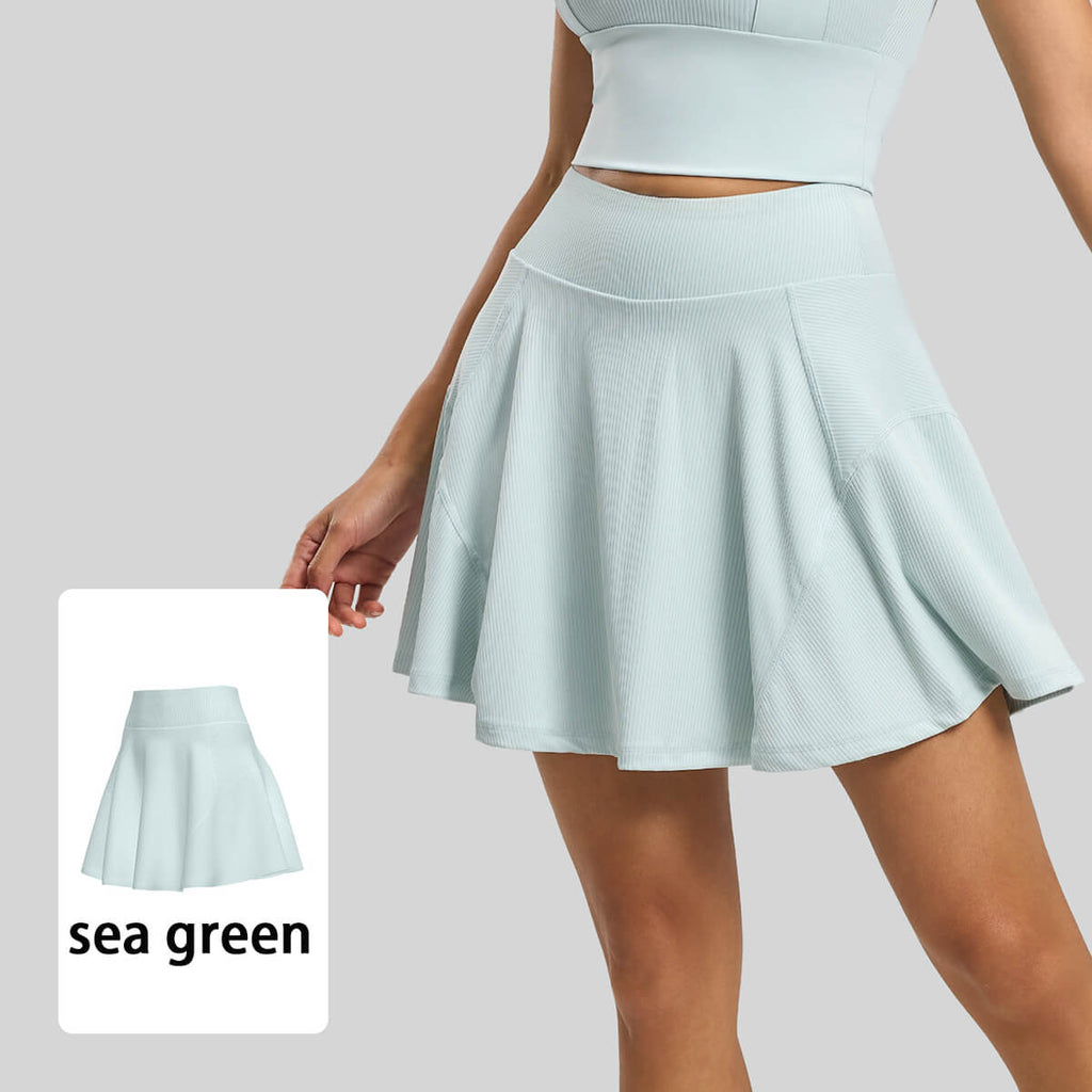 Sea green yoga tennis skirt featuring a tummy-control waistband and moisture-wicking ribbed material for women.
