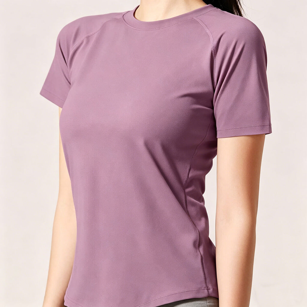 Side profile of a mauve slim-fit women's activewear tee with raglan sleeves and moisture-wicking fabric, ideal for running and fitness.
