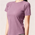 Side profile of a mauve slim-fit women's activewear tee with raglan sleeves and moisture-wicking fabric, ideal for running and fitness.