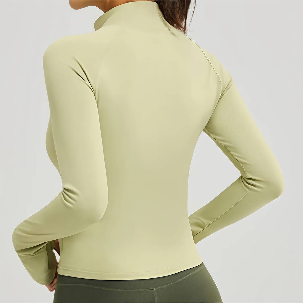 Back view of the women's slim-fit yoga jacket highlighting the mock neck and sleek raglan sleeves for a modern sporty look.