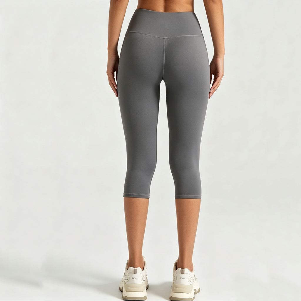 Back view of squat-proof high-waisted yoga capris in grey, showcasing non-see-through fabric and glute contouring