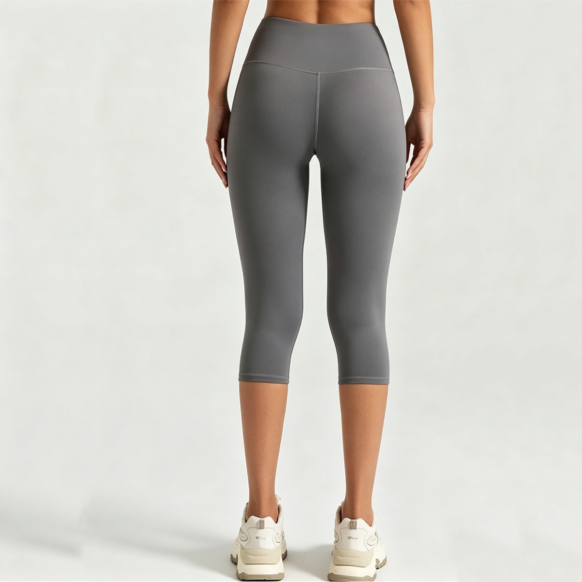 Back view of squat-proof high-waisted yoga capris in grey, showcasing non-see-through fabric and glute contouring