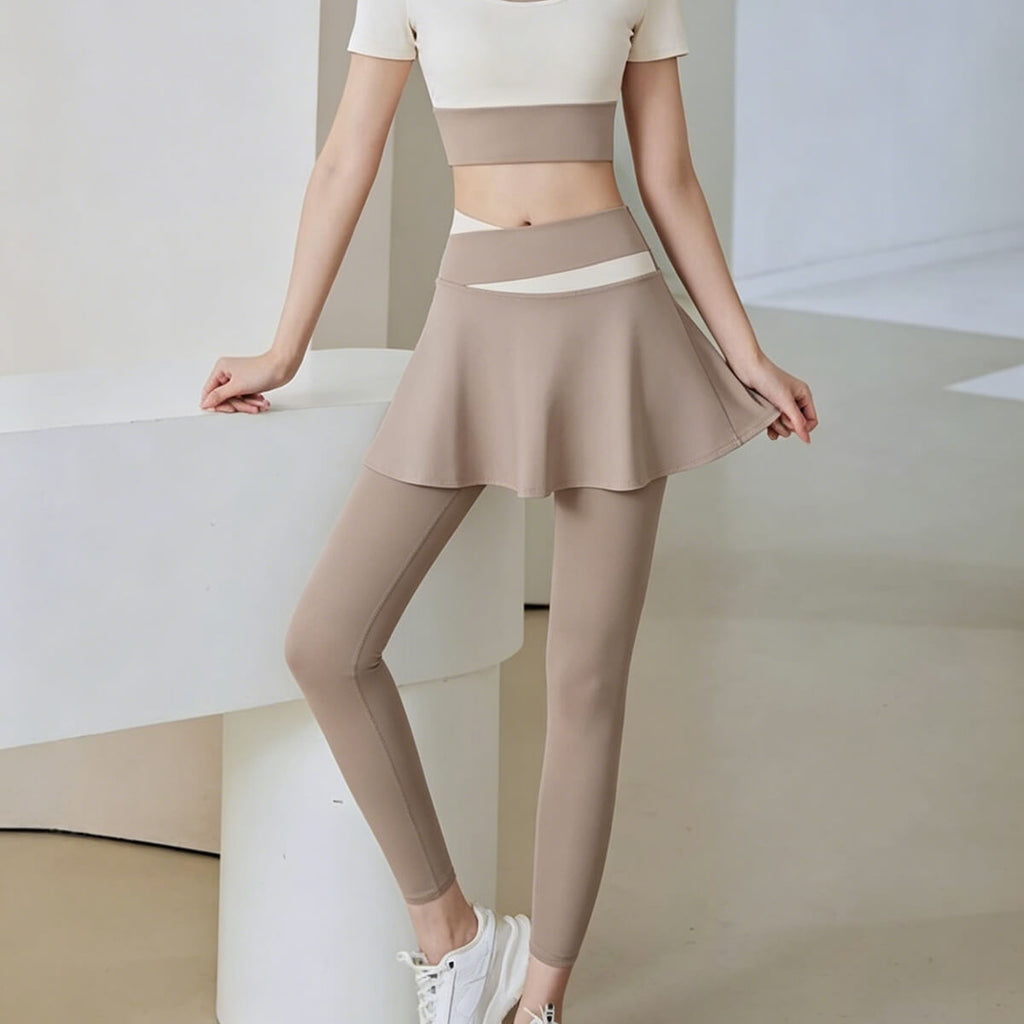 Close-up of light coffee skirted leggings showcasing the ruffled skirt hem and the intricate color-blocked waistband craftsmanship