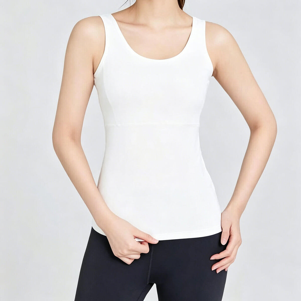 Front view of a crisp white workout top with an integrated bra, offering a sleek and clean look for pilates and yoga sessions