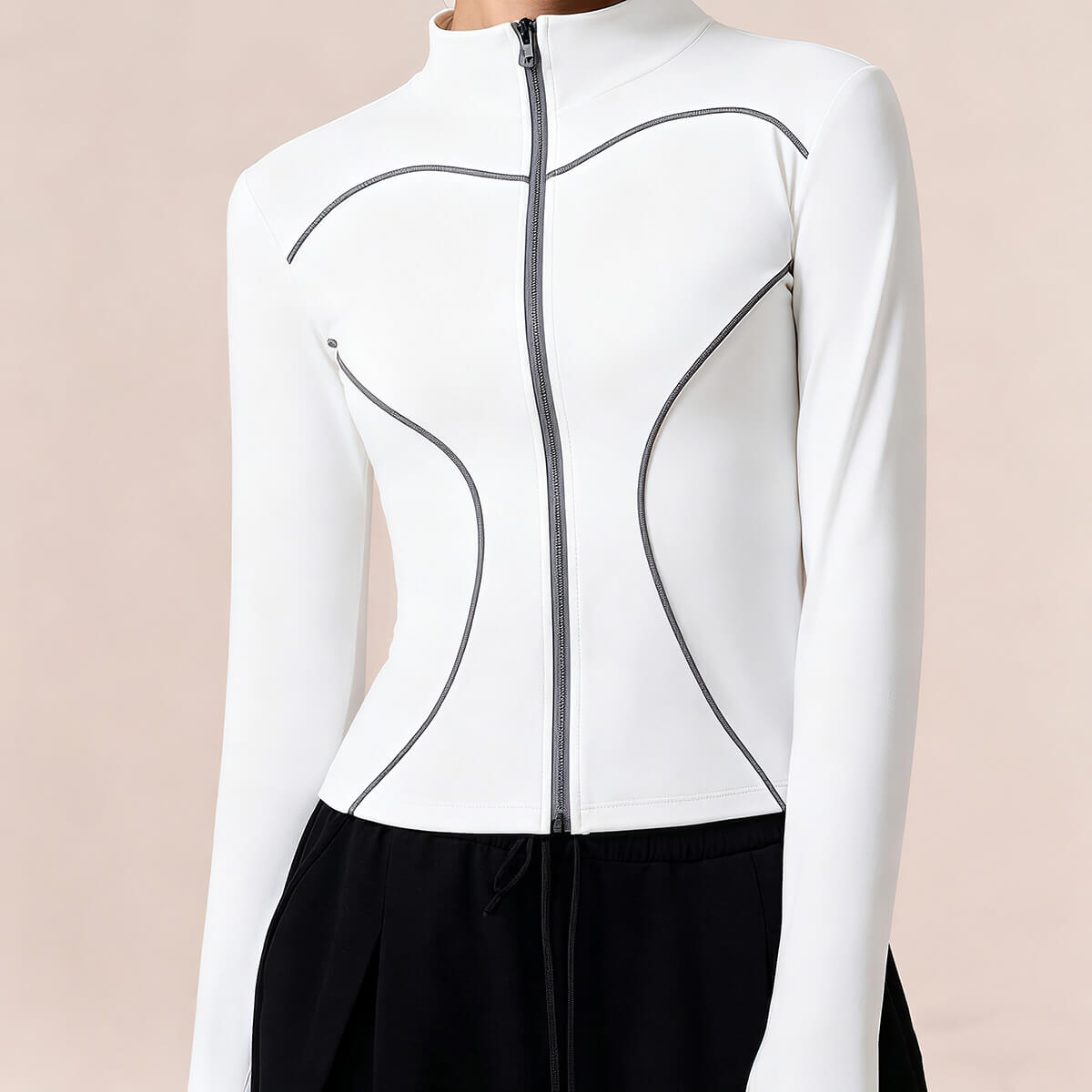 Detailed view of a white textured performance zip-up jacket for women, highlighting the breathable fabric and slimming contrast piping.