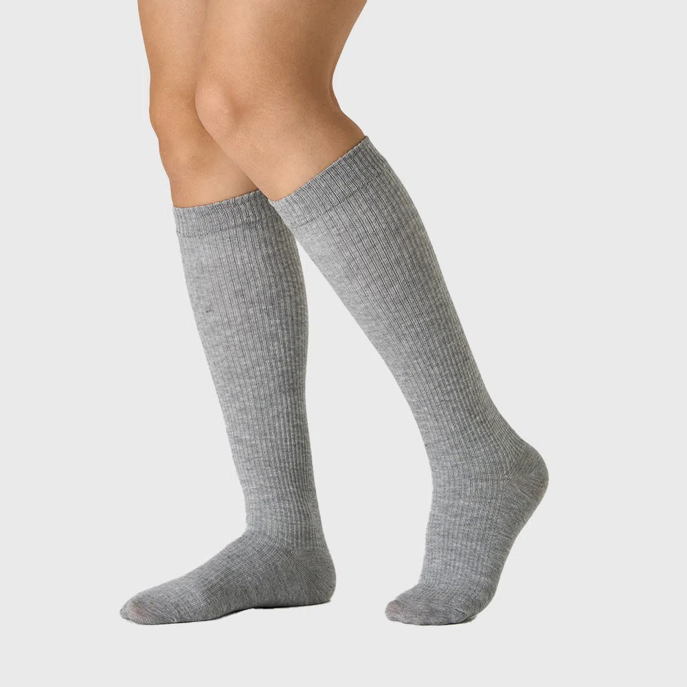 On-leg fit view of women's cotton ribbed compression socks in grey with custom logo, sportswear manufacturer.
