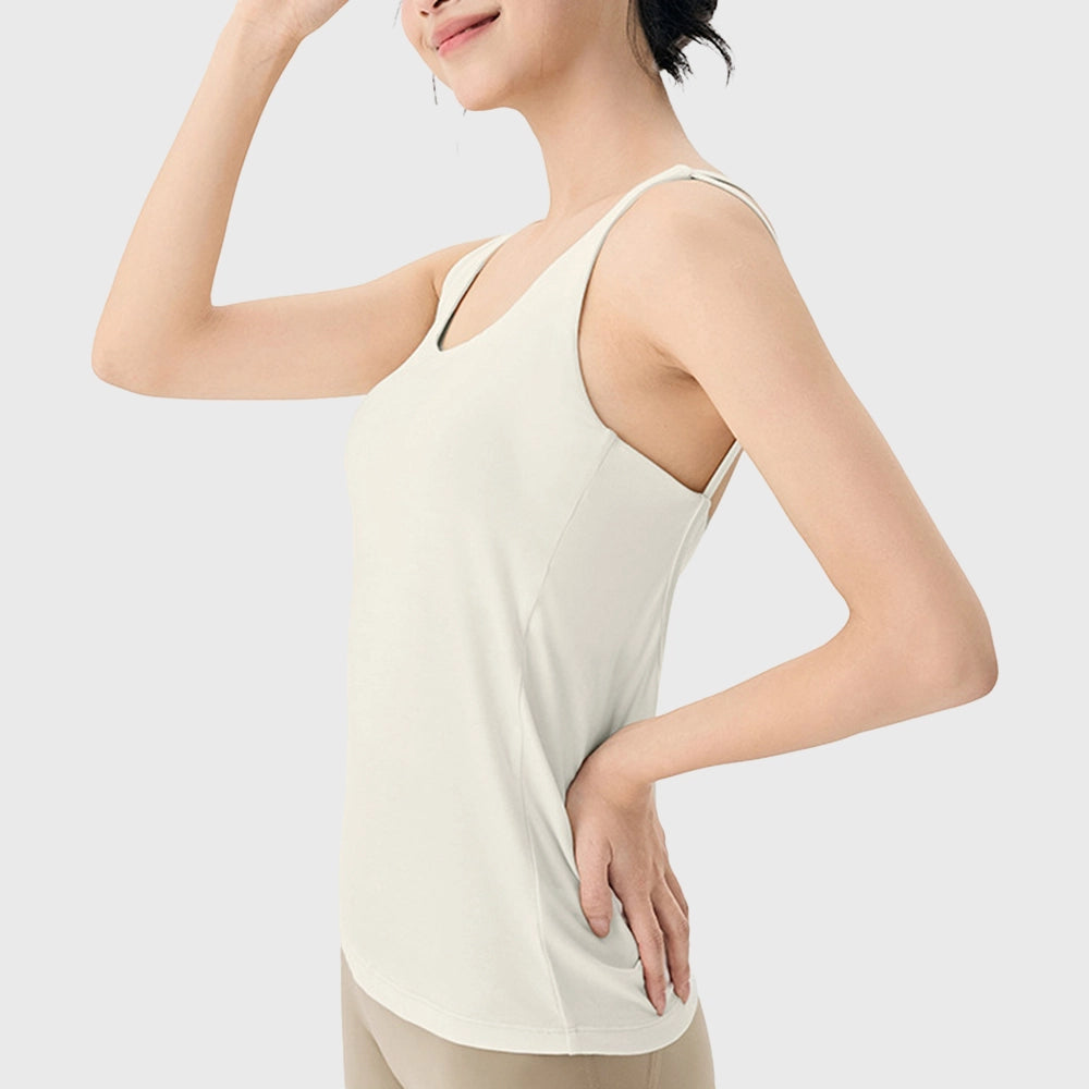 Side profile of women's 2 in 1 workout tank top with built-in bra in cream with custom logo, custom sportswear manufacturer.
