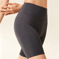 Close-up side view of women's 5-inch high-waisted biker shorts in charcoal gray, showing soft, stretchy fabric for yoga and gym.