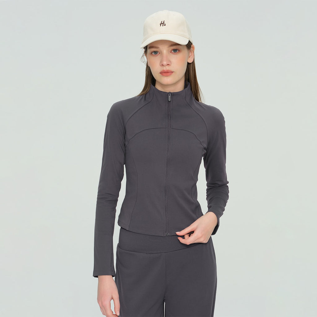 Model wearing a charcoal grey slim-fit workout jacket and matching activewear set.