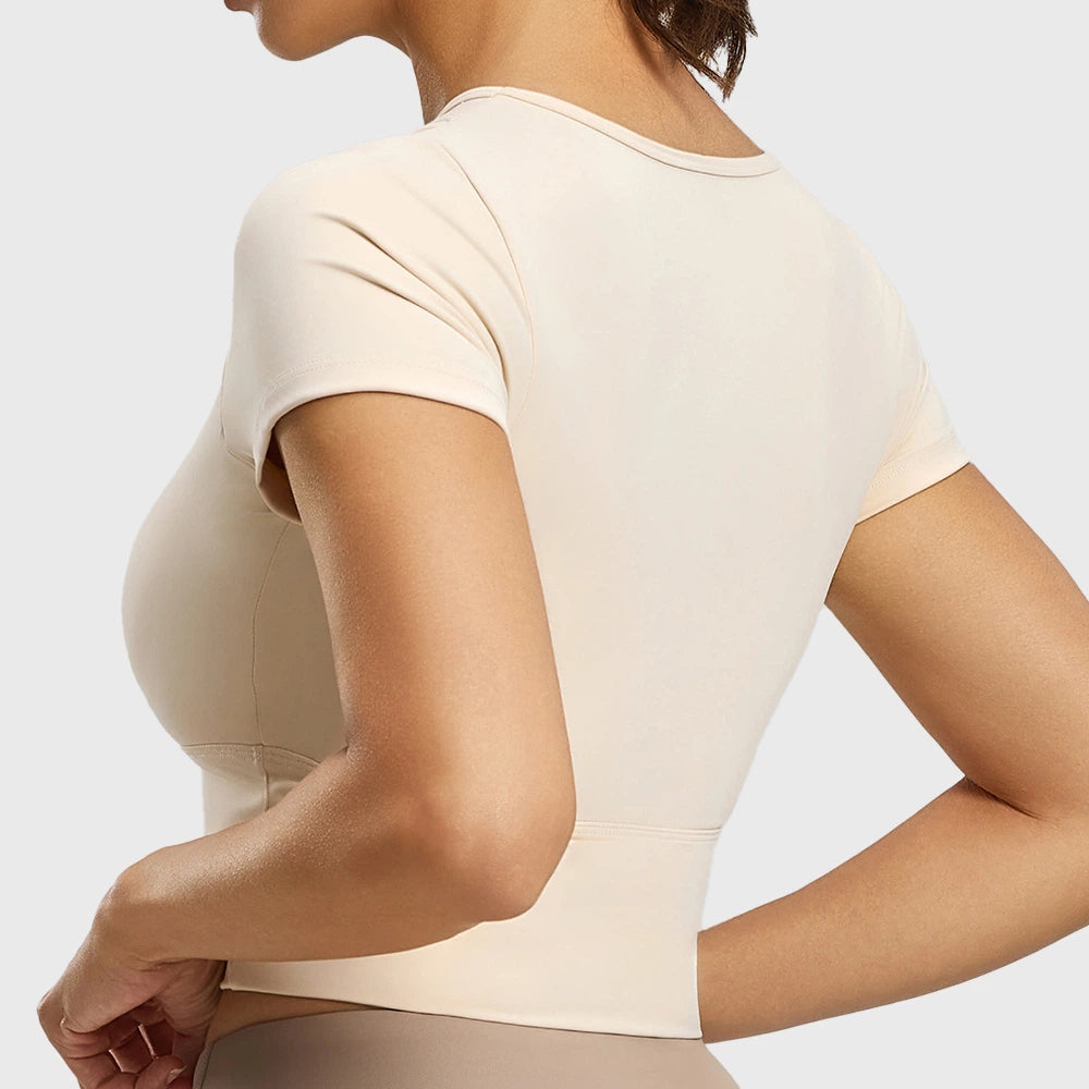 Back view of women's short sleeve padded yoga crop top in cream with custom logo, OEM activewear manufacturer.
