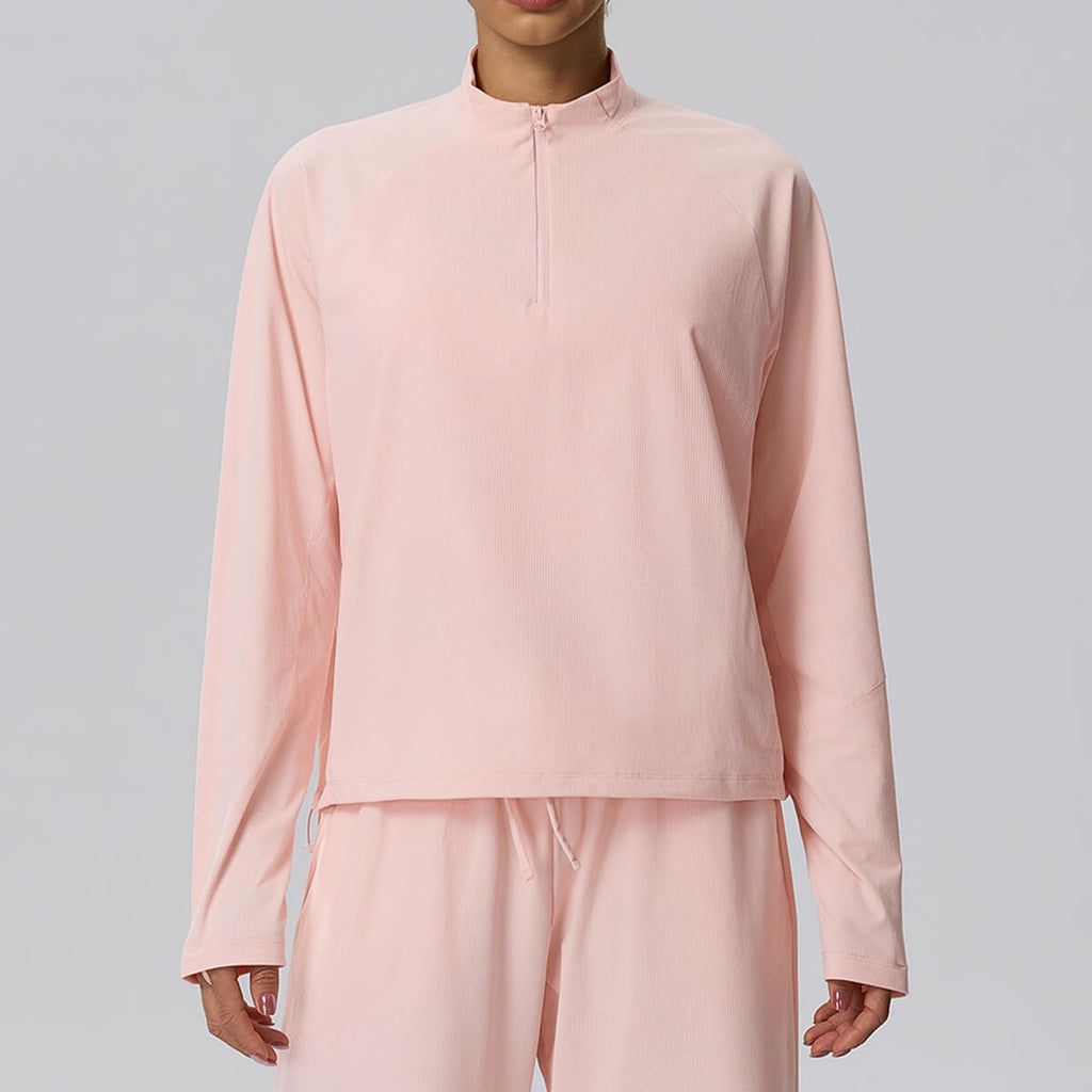 Light pink women's cropped athletic pullover, perfect for running or yoga, shown from the front.