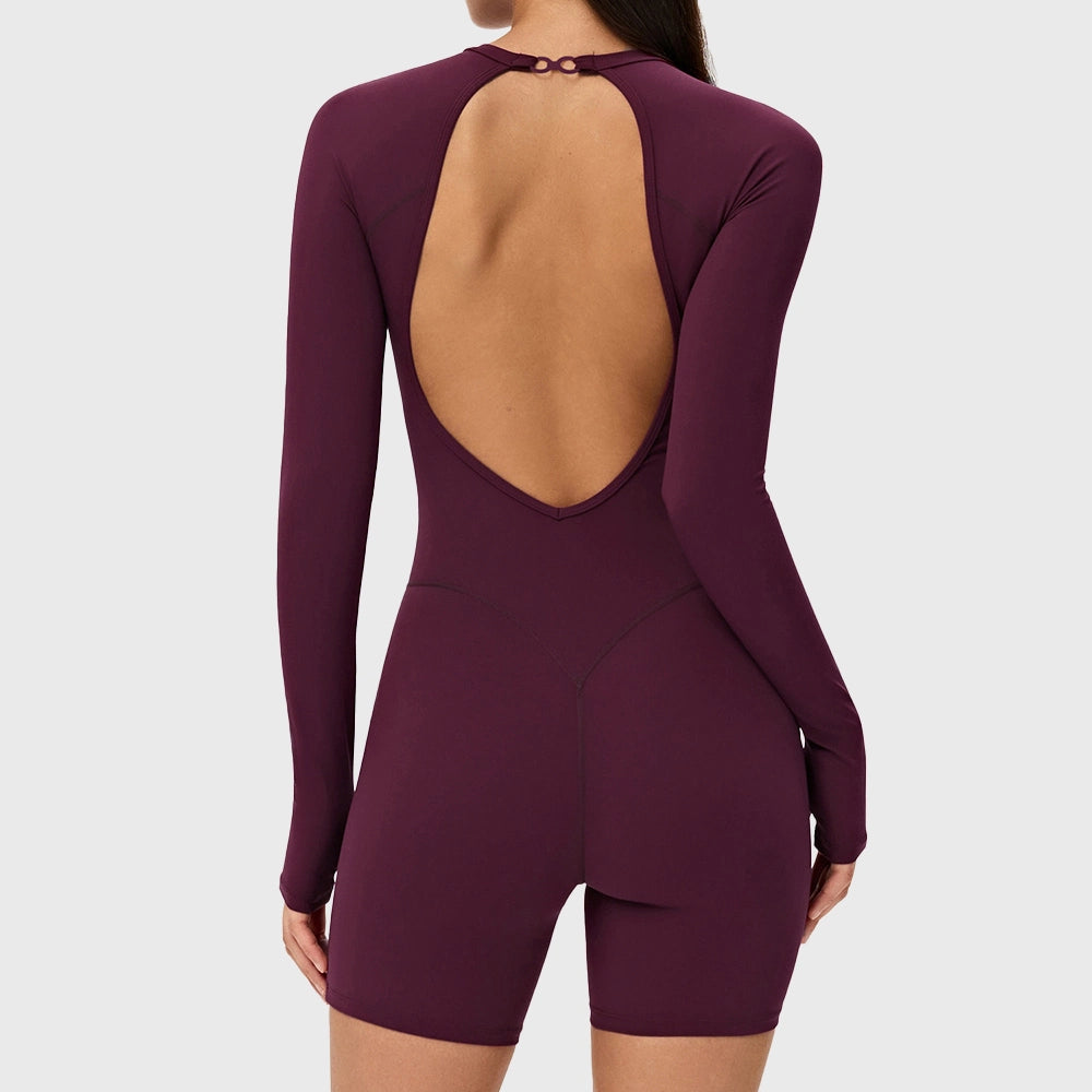 Back view showing open back and V-shaped booty lifting seam on women's burgundy yoga romper with custom logo, OEM activewear manufacturer.