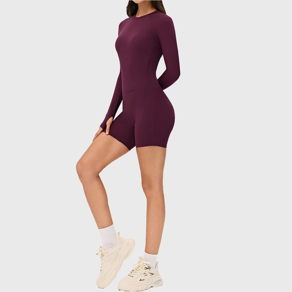 Side profile of women's long sleeve biker short yoga unitard in burgundy with custom logo, fitness clothing manufacturer.