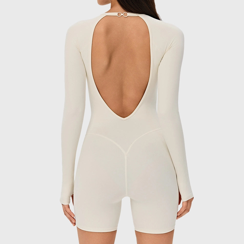 Back view of women's open back athletic workout romper with V-contour waist in cream with custom logo, private label manufacturer.