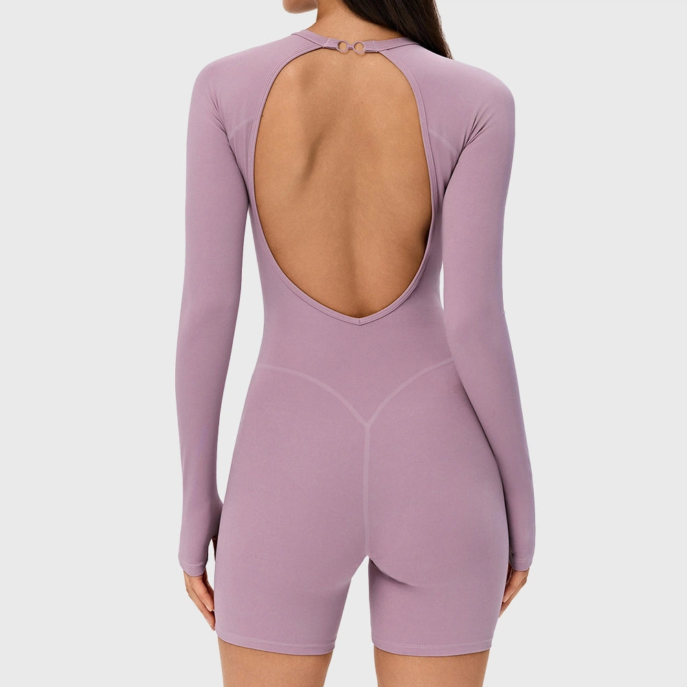 Back view of women's backless long sleeve biker short unitard with removable pads in lilac with custom logo, custom sportswear manufacturer.