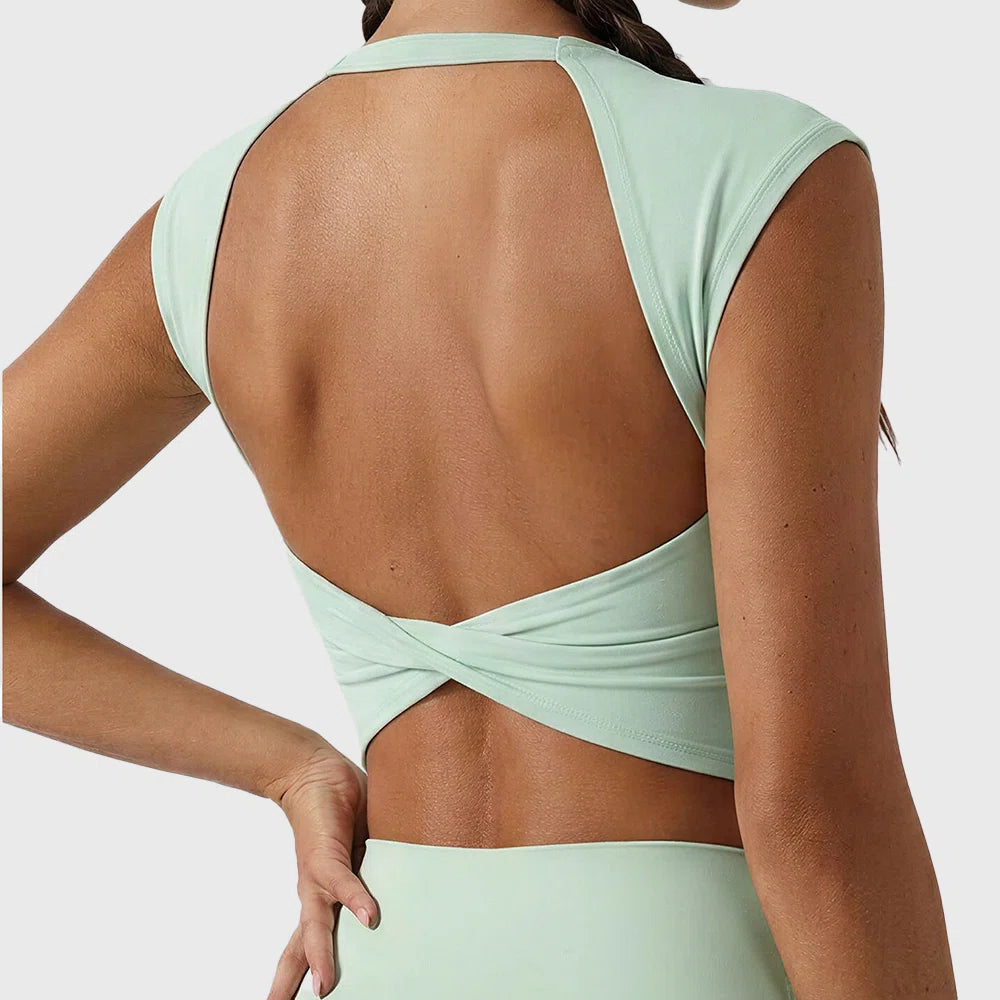 Backless cross twist detail on mint green women's workout crop top with custom logo, made by fitness apparel manufacturer.