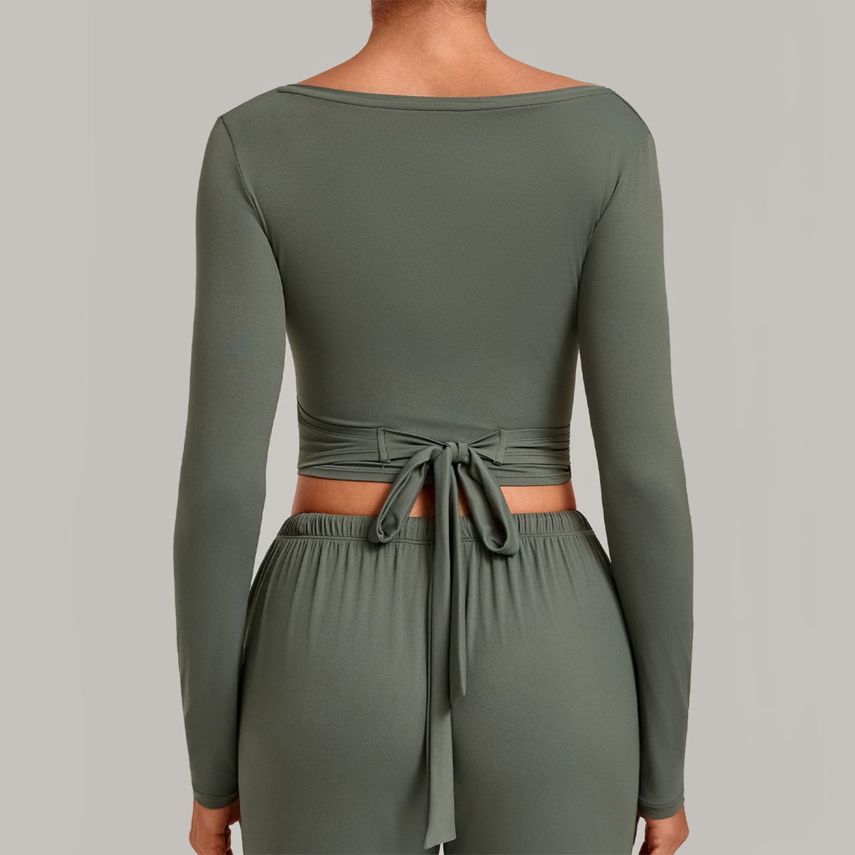 Straight back view of a sage green long-sleeve wrap top showing waist tie.