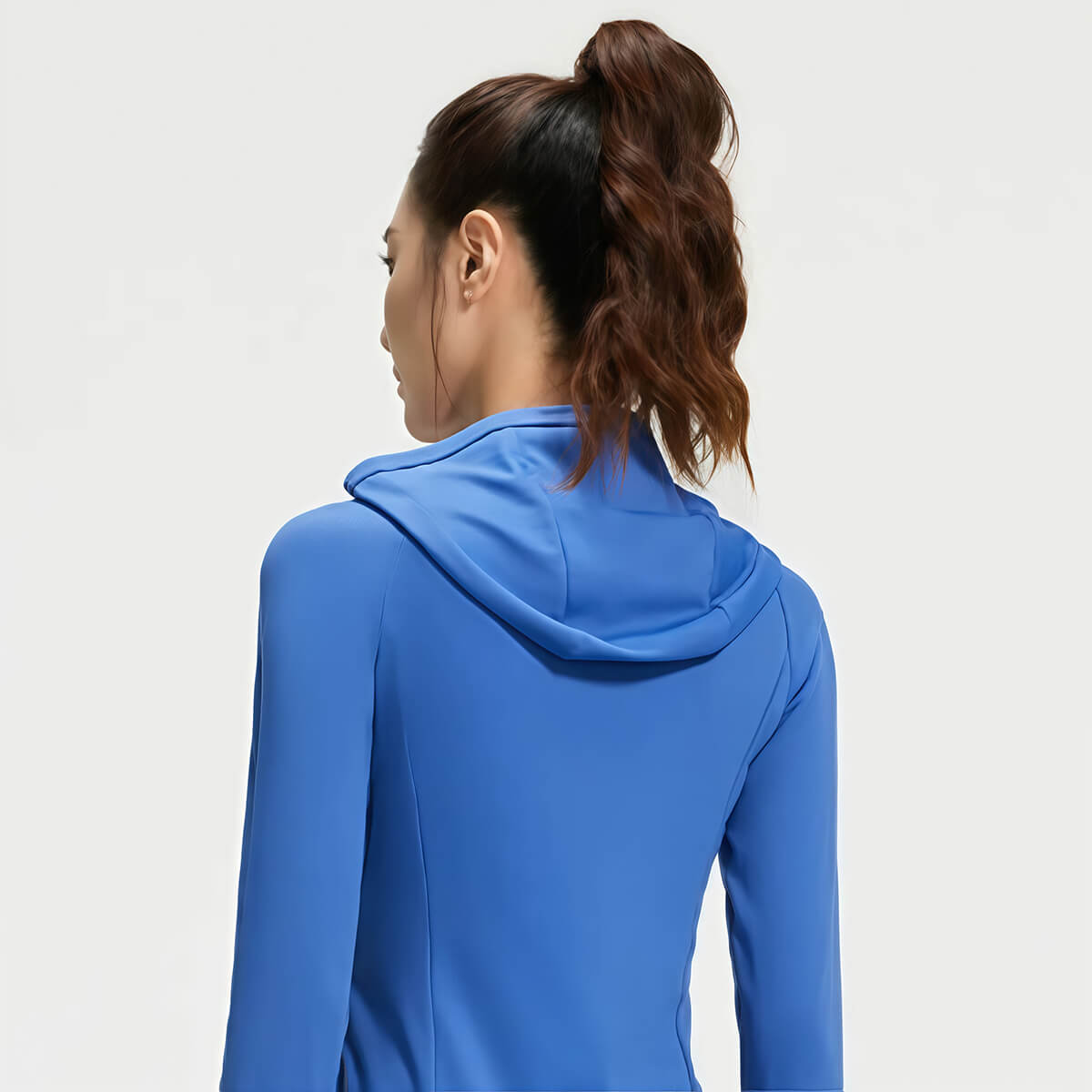 Back view of a women's blue workout hoodie showing the protective hood and fitted design.