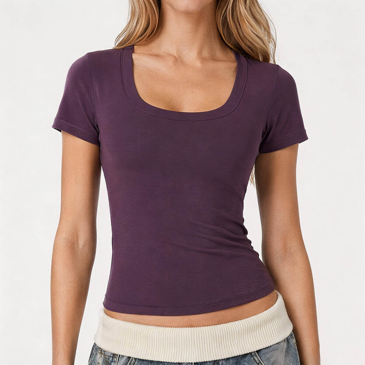 A model wearing a plum purple body-hugging short sleeve tee with a wide scoop neckline and stretchy athletic material.