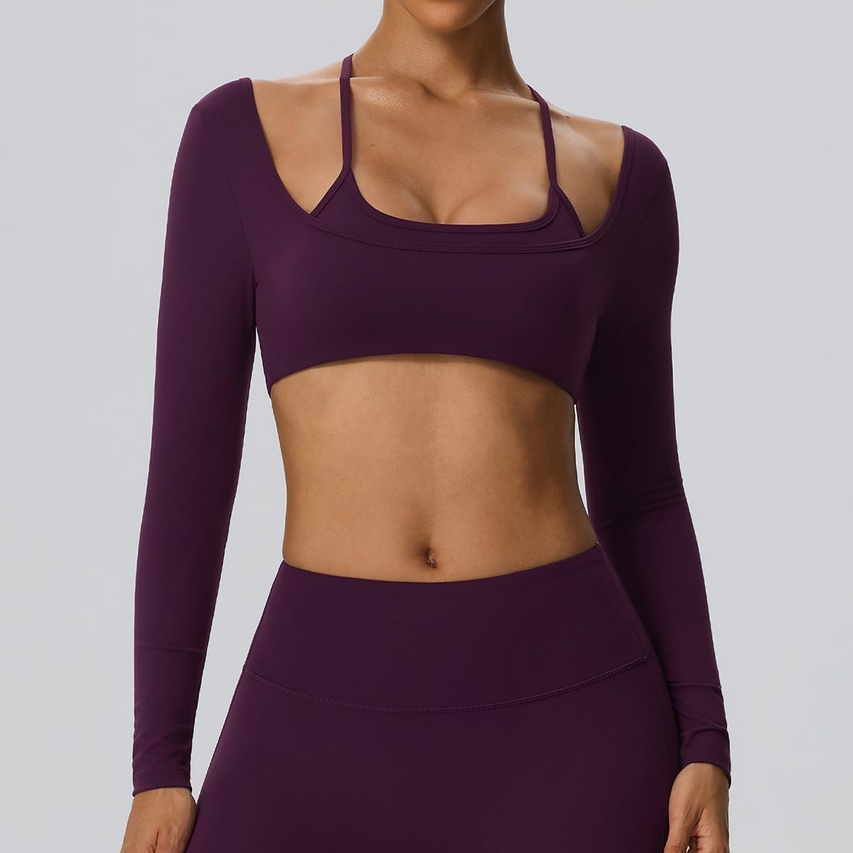 Front view of a deep plum purple 2-in-1 long sleeve sports bra.