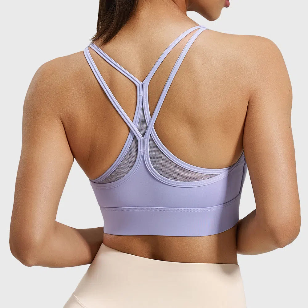 Breathable mesh panel and racerback detail on lilac yoga bra with custom logo, made by fitness apparel manufacturer.
