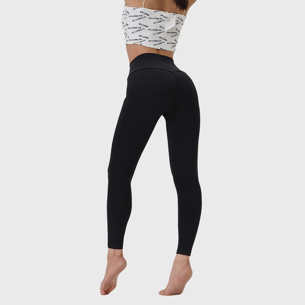 Back view of women's high rise booty lifting yoga leggings in black with custom logo, private label manufacturer.
