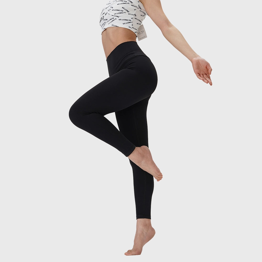 Dynamic side view of women's buttery soft high waist yoga leggings in black with custom logo, OEM activewear manufacturer.
