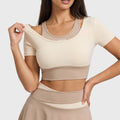 Women's two-tone padded athletic running crop top in tan and cream with custom logo, private label manufacturer - front view.