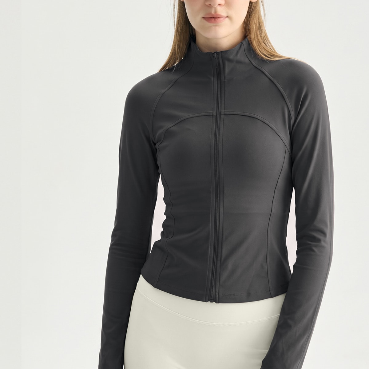 Front view of a dark charcoal grey fully zipped athletic track jacket.