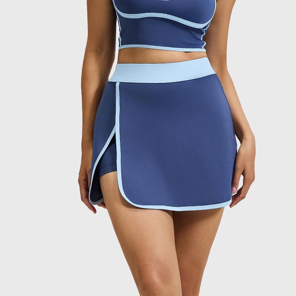 Women's contrast piping 2-in-1 athletic tennis skort in navy blue with custom logo, sportswear manufacturer - front view.
