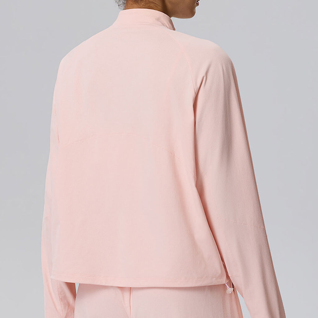 Back view of a women's light pink cropped athletic pullover, showing the clean seams and raglan sleeves.
