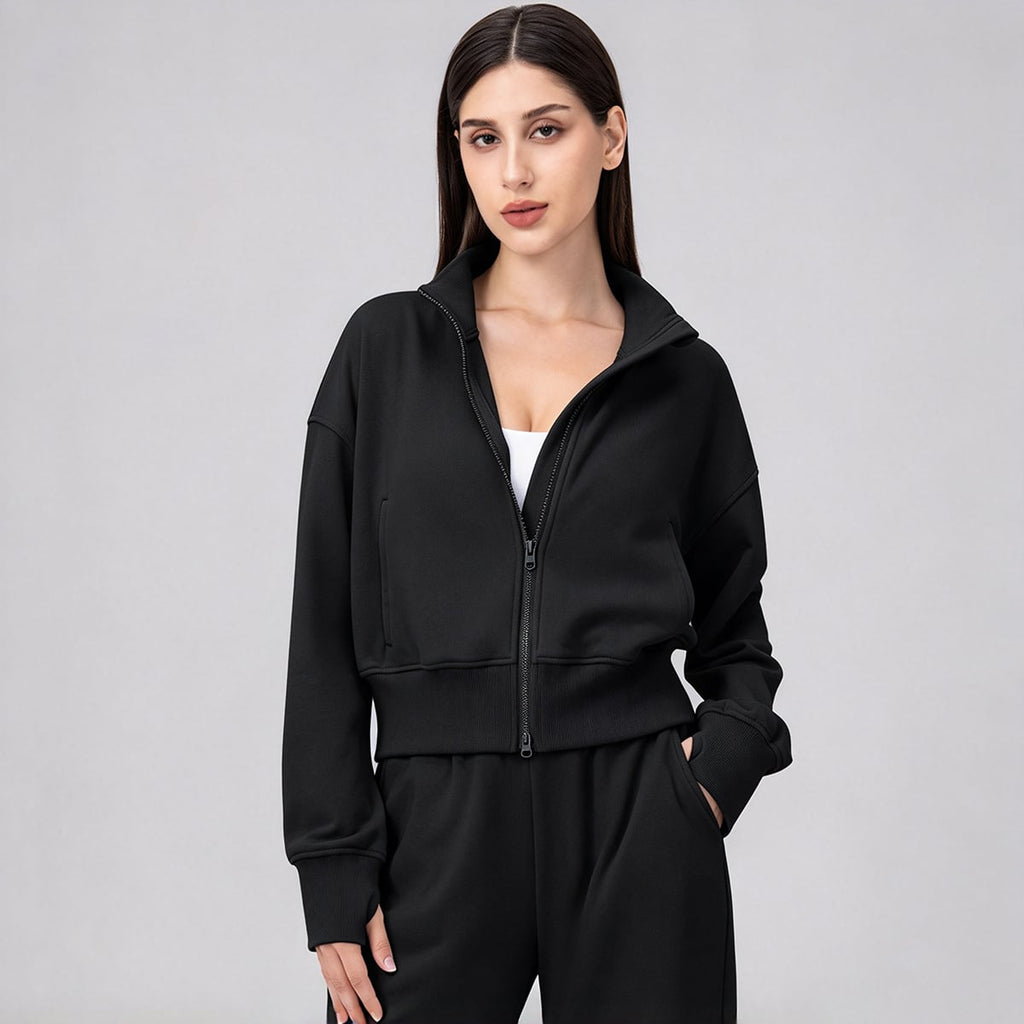 Front view of a black oversized full-zip workout jacket with pockets.
