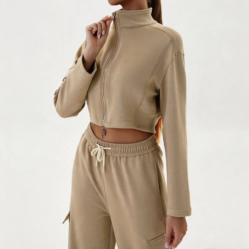 Front view of a women's two-piece khaki cargo sweatsuit featuring a cropped zip-up mock neck jacket and matching joggers.