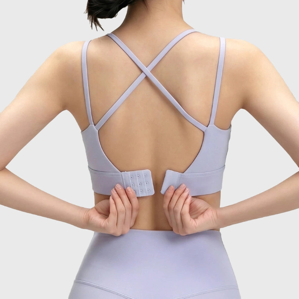 Adjustable hook and eye clasp on lilac cross back yoga sports bra with custom logo, made by fitness apparel manufacturer.