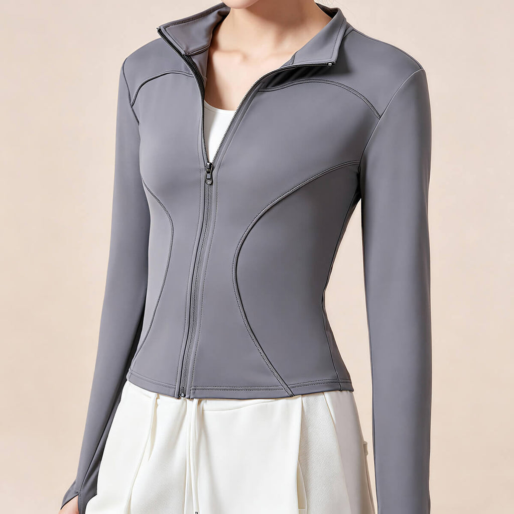 Three-quarter view of a dark grey women's running jacket made from moisture-wicking performance fabric with a high neck design.