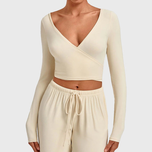 Women's deep V-neck long sleeve wrap crop top in cream with custom logo, OEM activewear manufacturer - front view.