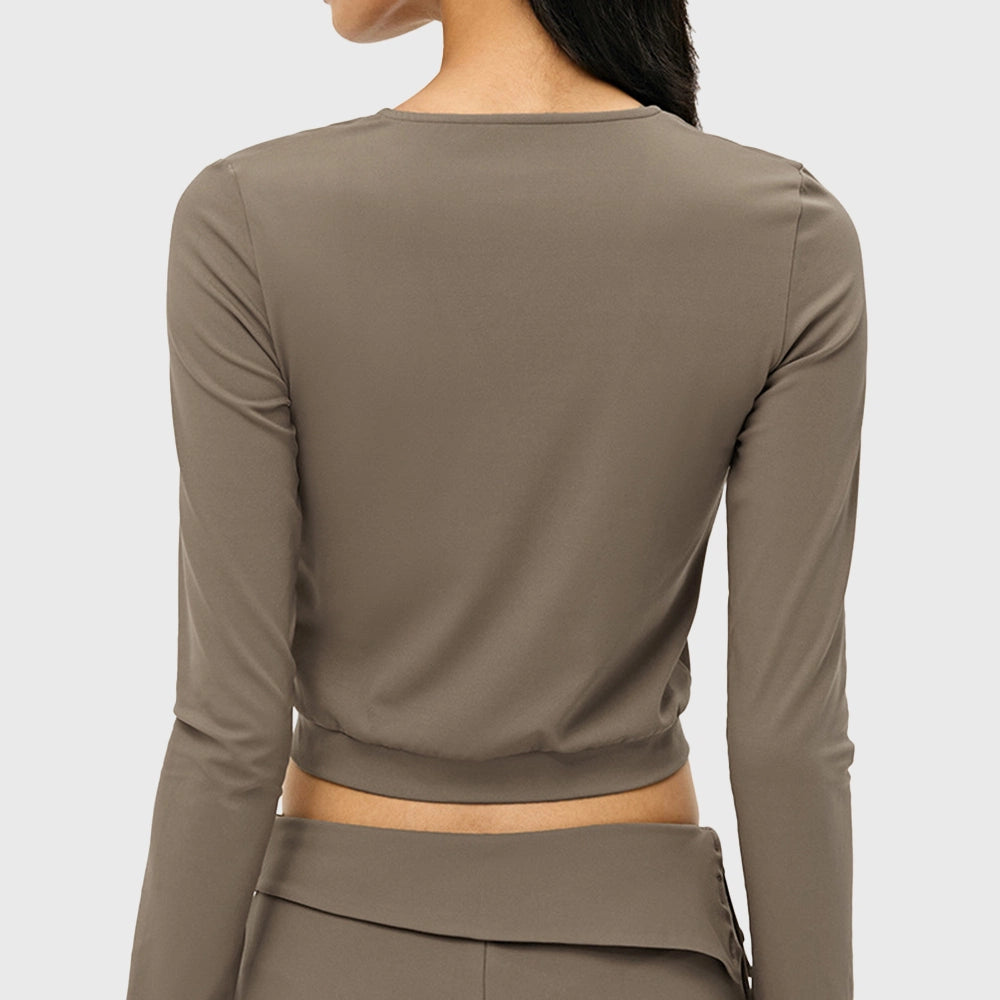 Back view of women's long sleeve crop jacket in taupe with custom logo, direct clothing manufacturer.