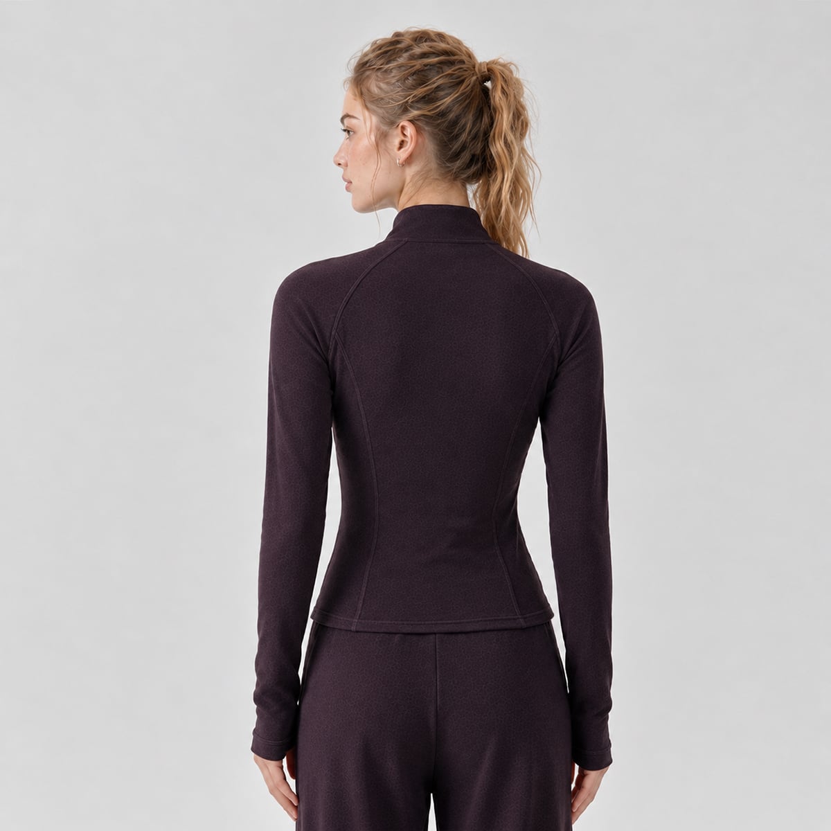 Back view of a deep plum thermal workout jacket with contour seams.