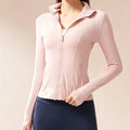 Front view of a women's dusty pink full-zip athletic jacket with a slim fit and stand-up collar for yoga and running