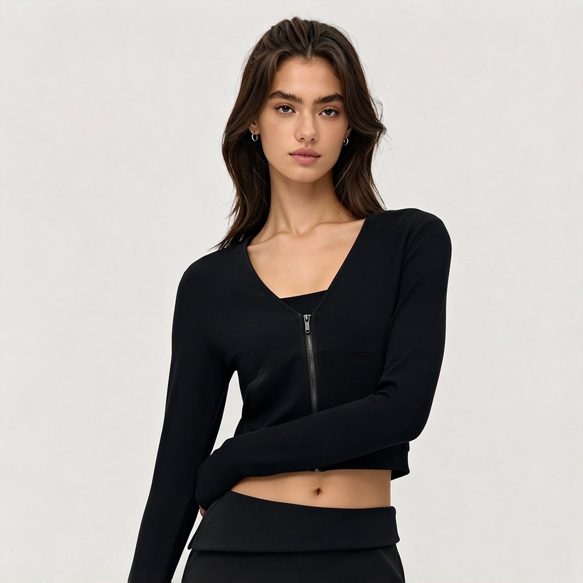 Front view of a classic black long-sleeve V-neck athletic crop jacket.