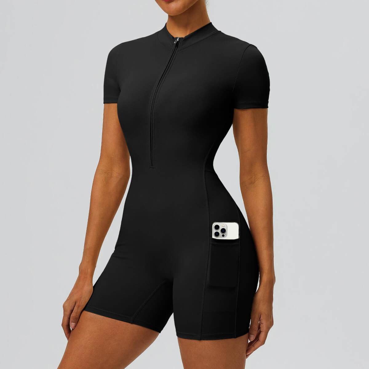Front view of a black short-sleeve workout onesie with side phone pocket.