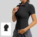 Close-up of the adjustable half-zip mock neck and stand-up collar on a women's black performance gym top.