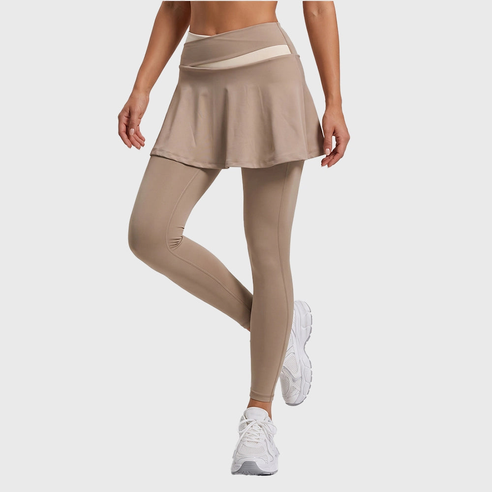 Front movement view of women's 2-in-1 crossover waist skirted yoga pants in tan with custom logo, OEM activewear manufacturer.