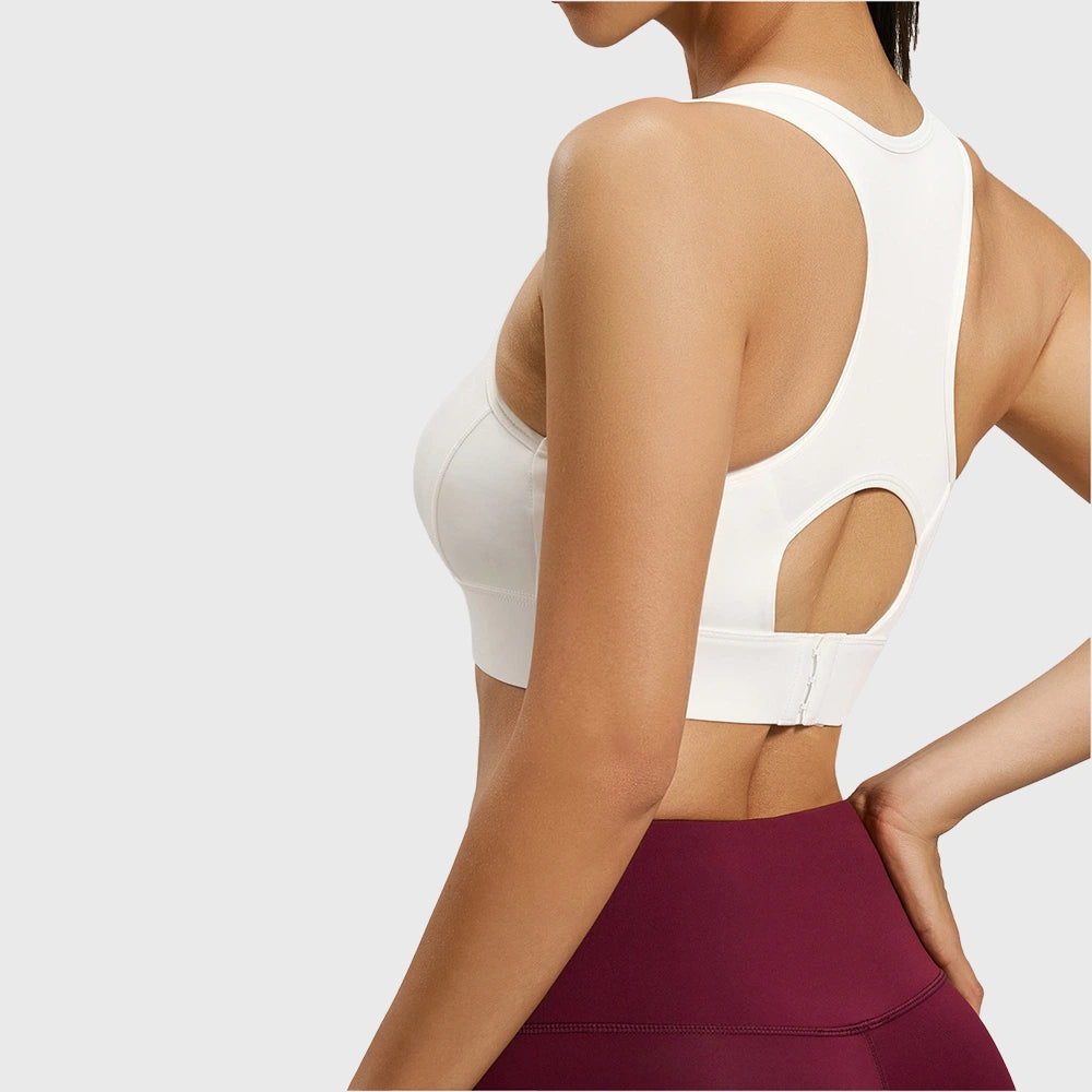 Back view showing keyhole racerback and hook-and-eye closure on women's white sports bra with custom logo, private label manufacturer.