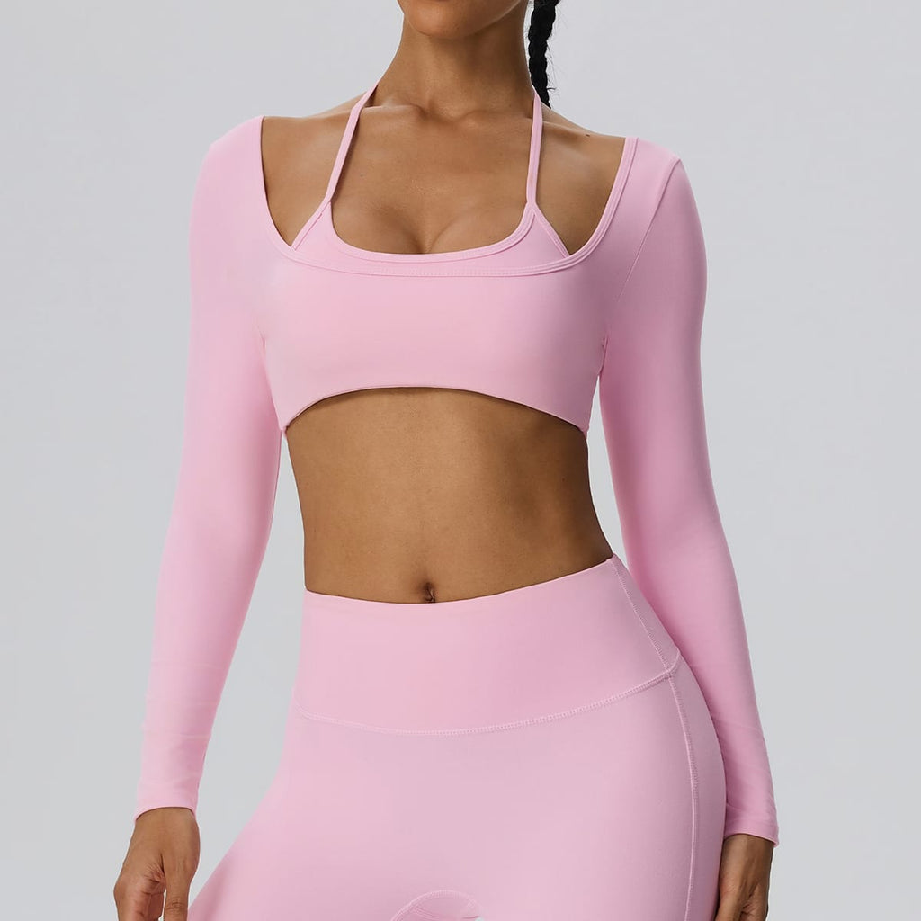 Woman wearing a light pink 2-in-1 long sleeve athletic bra top.