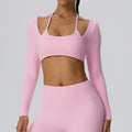 Woman wearing a light pink 2-in-1 long sleeve athletic bra top.
