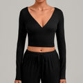 Front view of a black long-sleeve V-neck ballet wrap crop top.